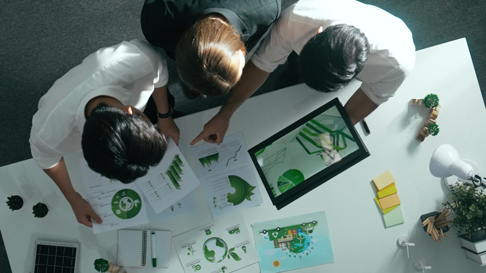 Team analysiert ESG Bericht mit Refurbished IT Geräten und Nachhaltigkeitsdaten am Laptop